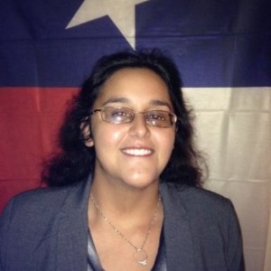 Hillary Corgey in front of Texas Flag