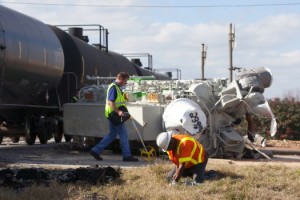 Crews work to clean up a wreck after an 18-wheeler collided with a train at the HWY 290 frontage road and Tegle Road Friday, Jan. 25, 2013, in Cypress, TX. (Cody Duty / Houston Chronicle)